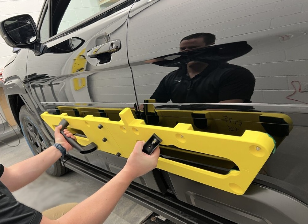 斯巴鲁工程师正在定位一个3D打印的安装夹具。照片由Stratasys提供。